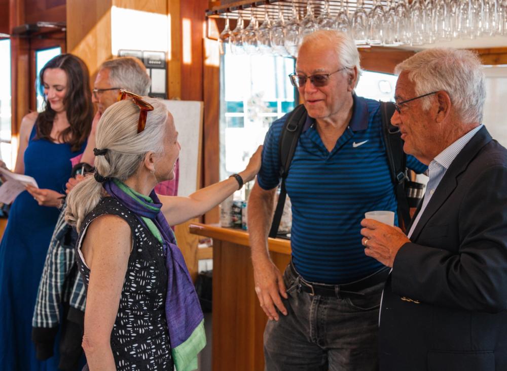 photo of Erika Goldman, Marty Blaser, and Larry Budish, with Laura Hart and Bob Kertzner in the background