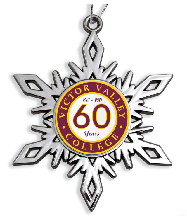 Silver metal snowflake ornament with a maroon and gold center insert marking a college's 60th anniversary, hung on a silver cord