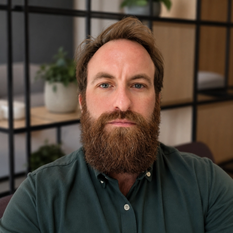 A full-bearded team-member in a modern office setting