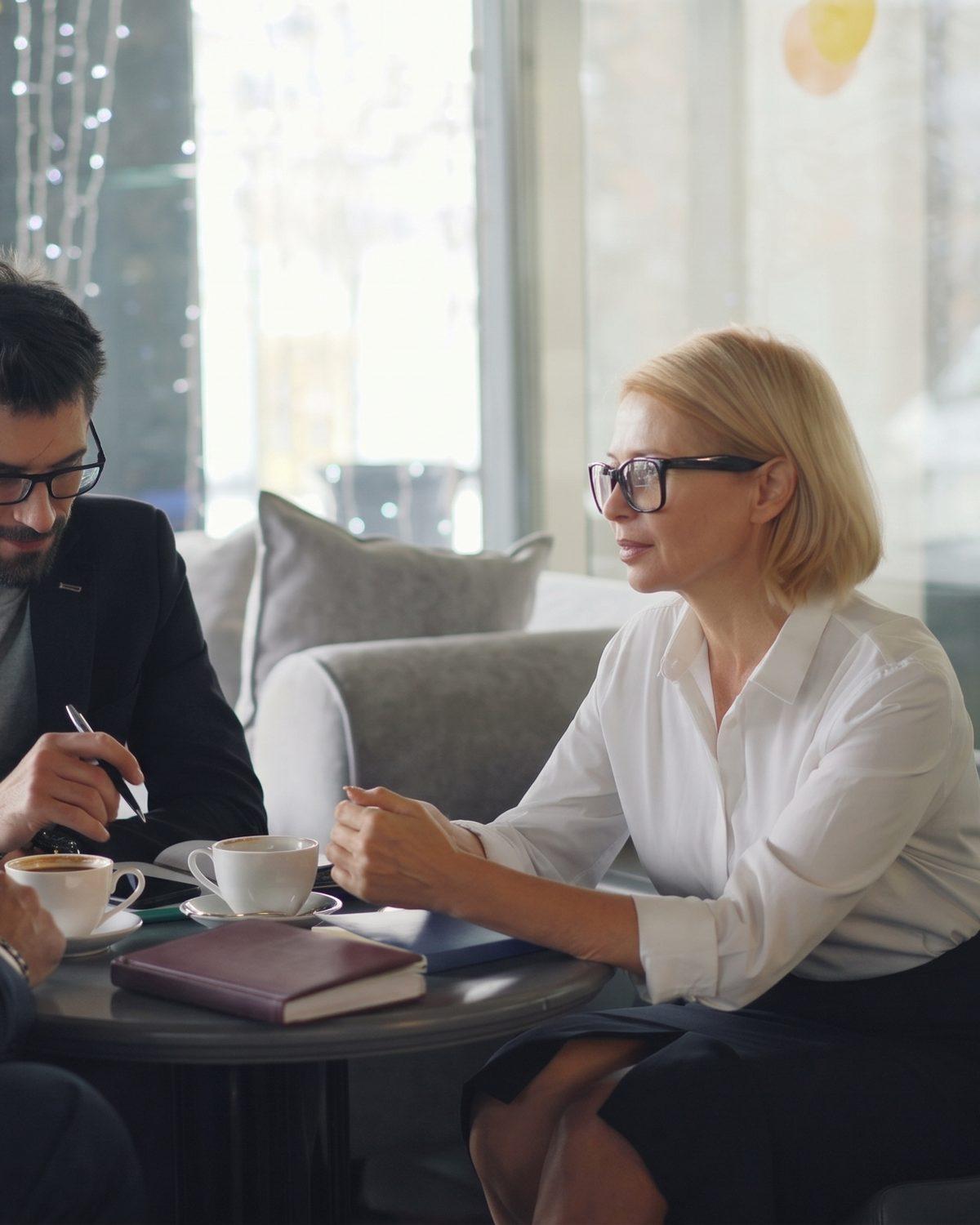 Two colleagues in conversation over coffee