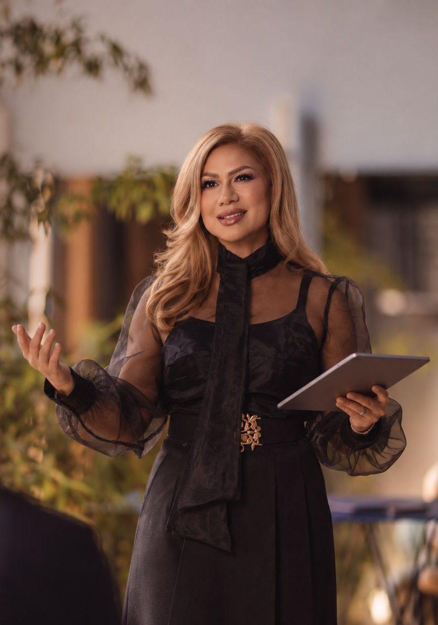 Wardah Harharah speaking, a tablet in one hand