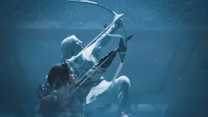 Ellie draws her bow, aiming upward. Behind her is a snow-covered statue of a Native American warrior in a similar pose.