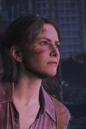 A close up of Tess with some scrapes on her forehead and below her eye, looking determinedly towards the sunrise offscreen, which casts her in a pink glow.