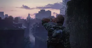 A shot from behind Joel as he scratches the back of his head, looking out at a misty pink sunrise. The dome of a government building is visible in the distance.