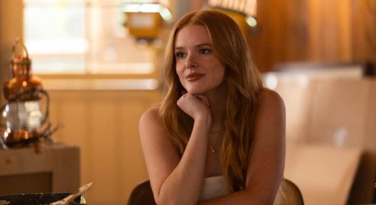 Portrait of Abigail Cowen showcasing her signature red hair and confident style