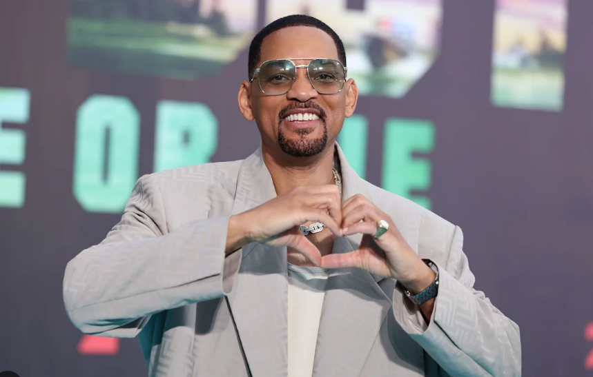 "Hollywood star Will Smith smiling warmly at a movie premiere."