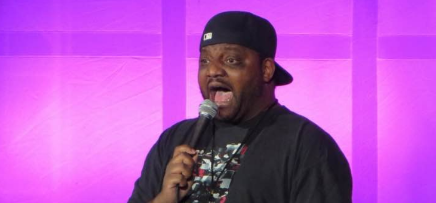 Aries Spears performing stand-up comedy on stage