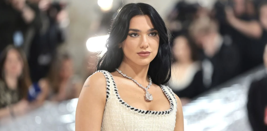 Dua Lipa performing live on stage during a concert