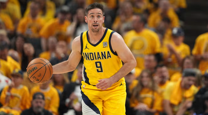 T.J. McConnell driving the ball down the court during an Indiana Pacers game.