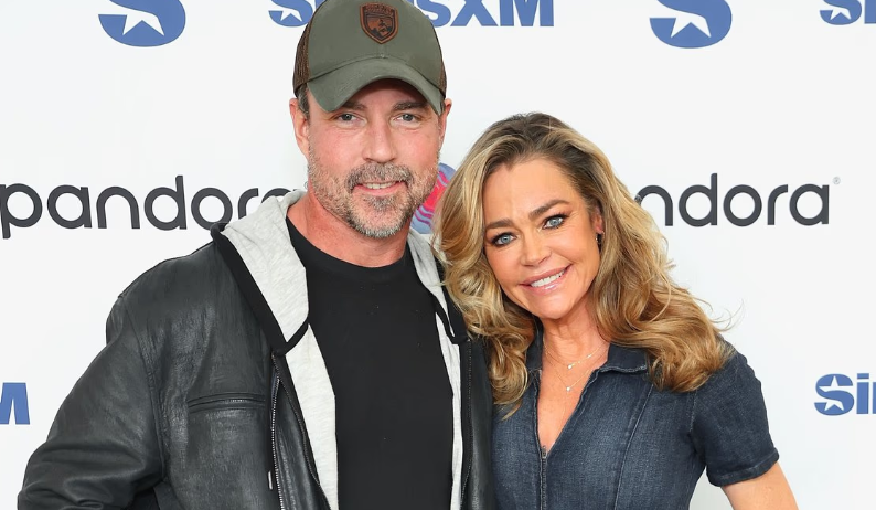 Aaron Phypers and Denise Richards together at a public event showing what does Denise Richards husband do.