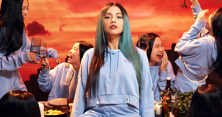 Malaysian fashion designer Kittie Yiyi posing in one of her signature bold, colorful, and creative outfits