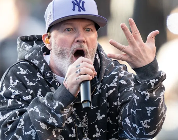 Fred Durst performing live on stage with his iconic red baseball cap during a 2026 tour concert.