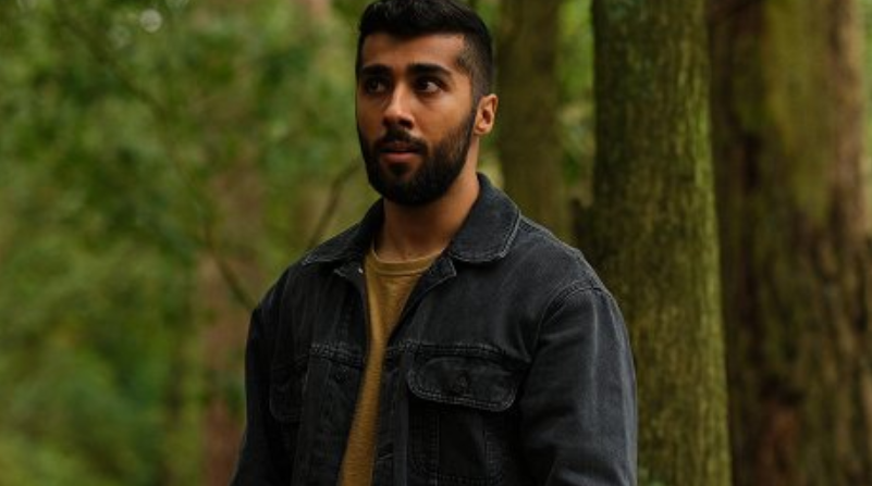 Chaneil Kular posing during an interview, showcasing the British star known for his roles in Sex Education and Accused.