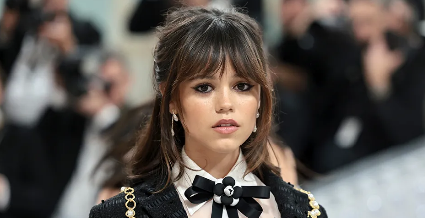 Jenna Ortega smiling at a red carpet event