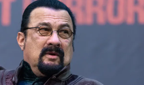 A young Steven Seagal practicing traditional Aikido martial arts techniques in a training uniform.