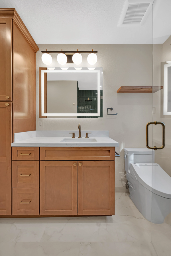 Guest bath, vanity with linen tower, LED mirror, and globe lights