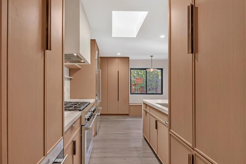 Walk-in closet, white oak cabinetry and LED shelving