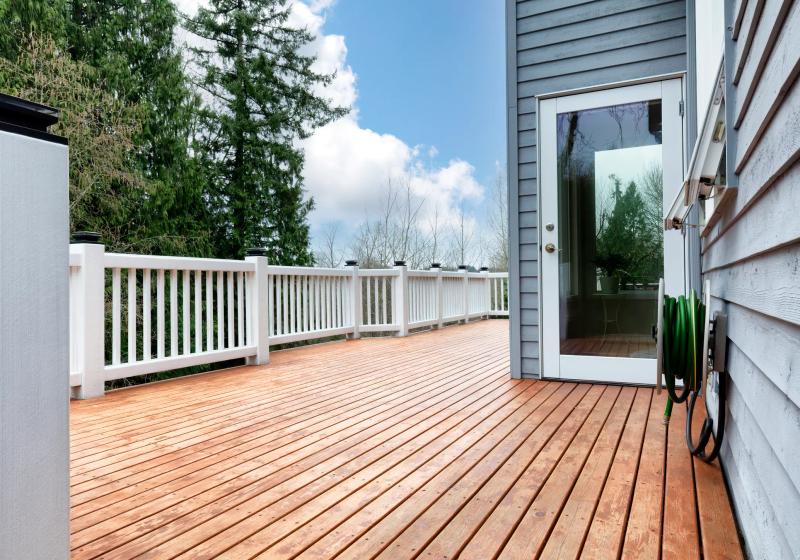 Deck with white composite railings and gray siding — San Mateo County