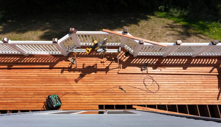 Aerial view of deck mid-construction — Bark and Build crew building elevated composite deck in San Mateo County