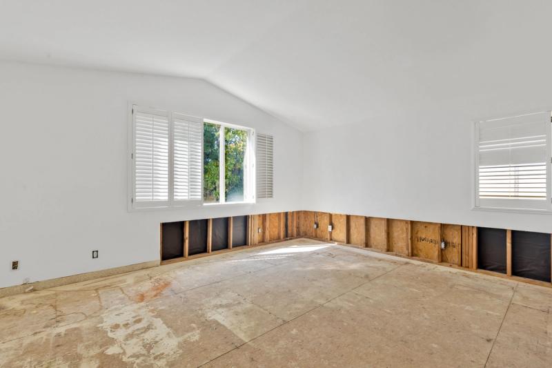 Sound attenuation — acoustic mineral wool and resilient channel installation on shared wall