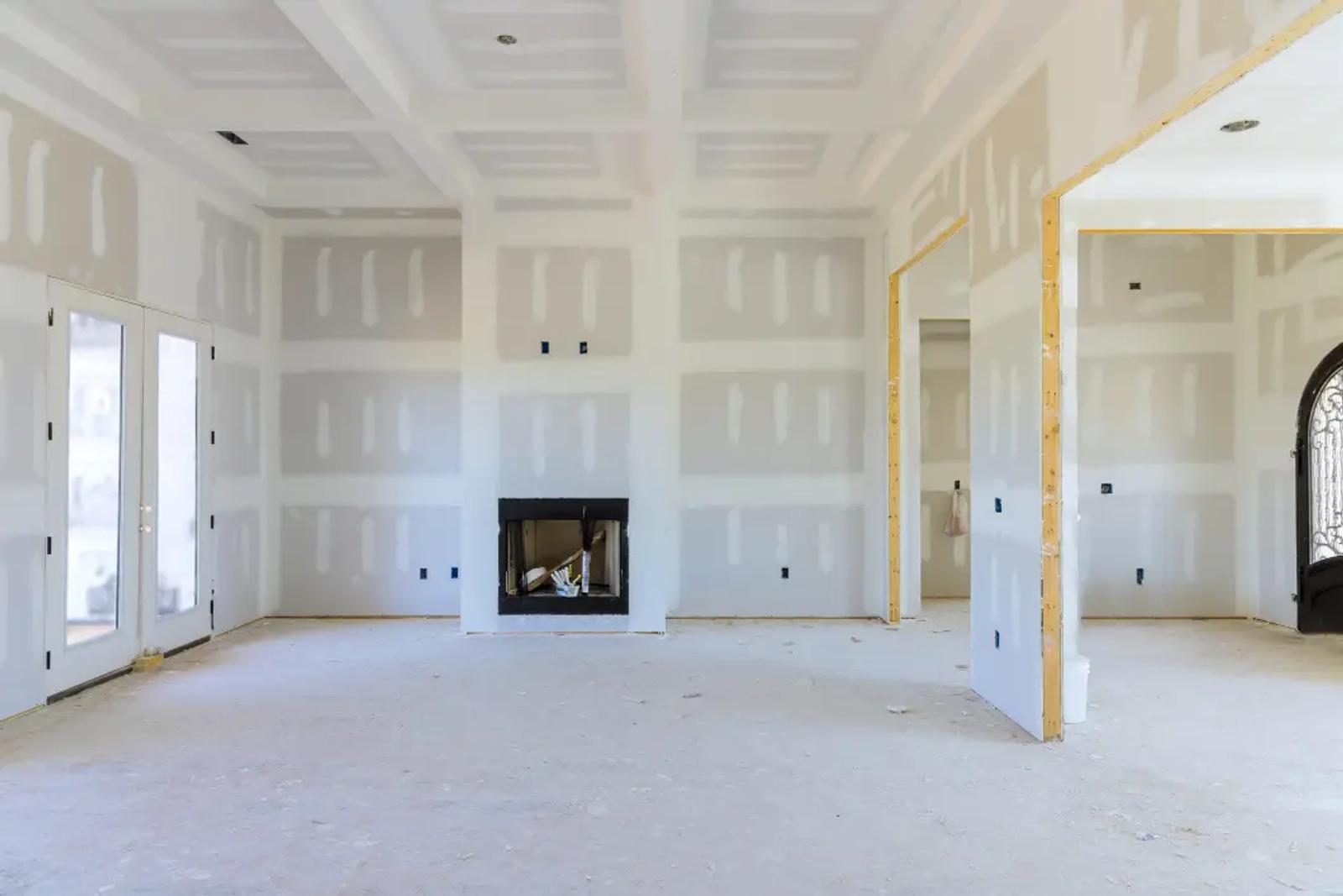 JADU post-drywall stage — Type X drywall installed, taped seams, ready for paint and finish
