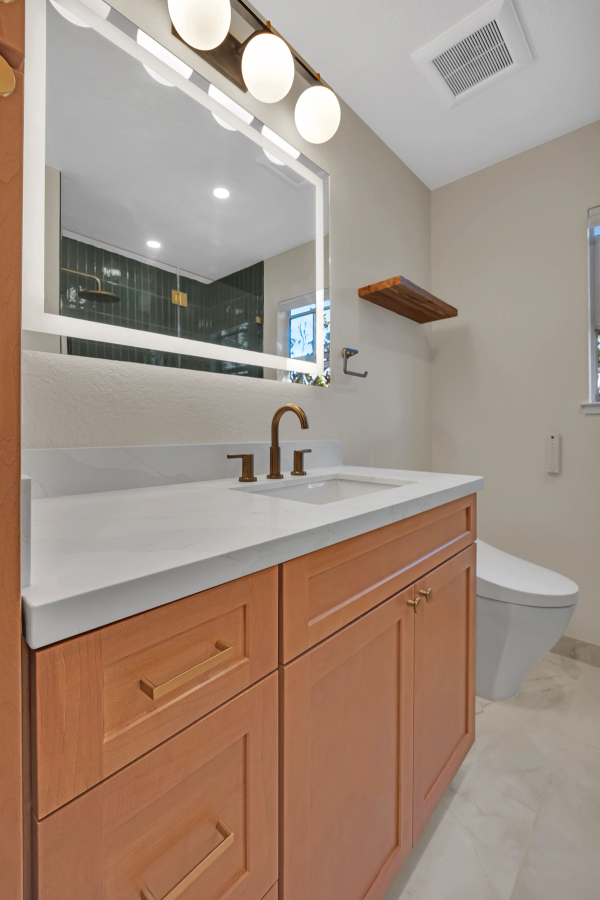 Guest bath, vanity closeup with quartz countertop and brass faucet