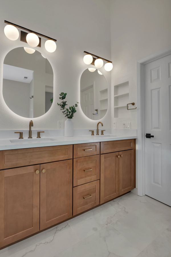 Master bath, double vanity with dual oval LED-backlit mirrors and globe light fixtures