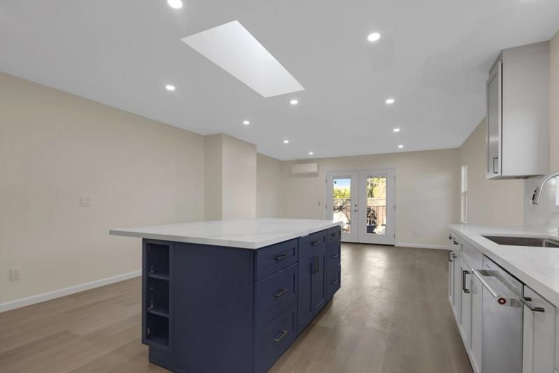 Kitchen, navy island toward French doors with skylight overhead