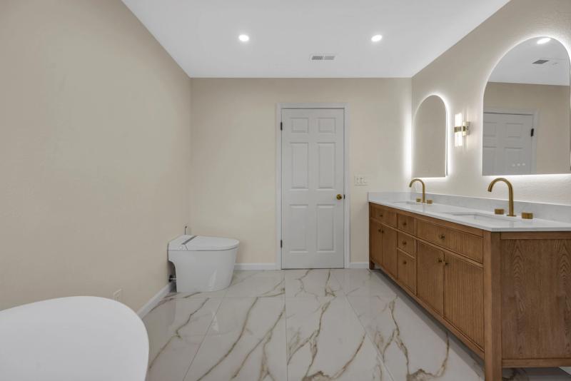 Master bath, vanity side with bidet toilet and freestanding tub visible