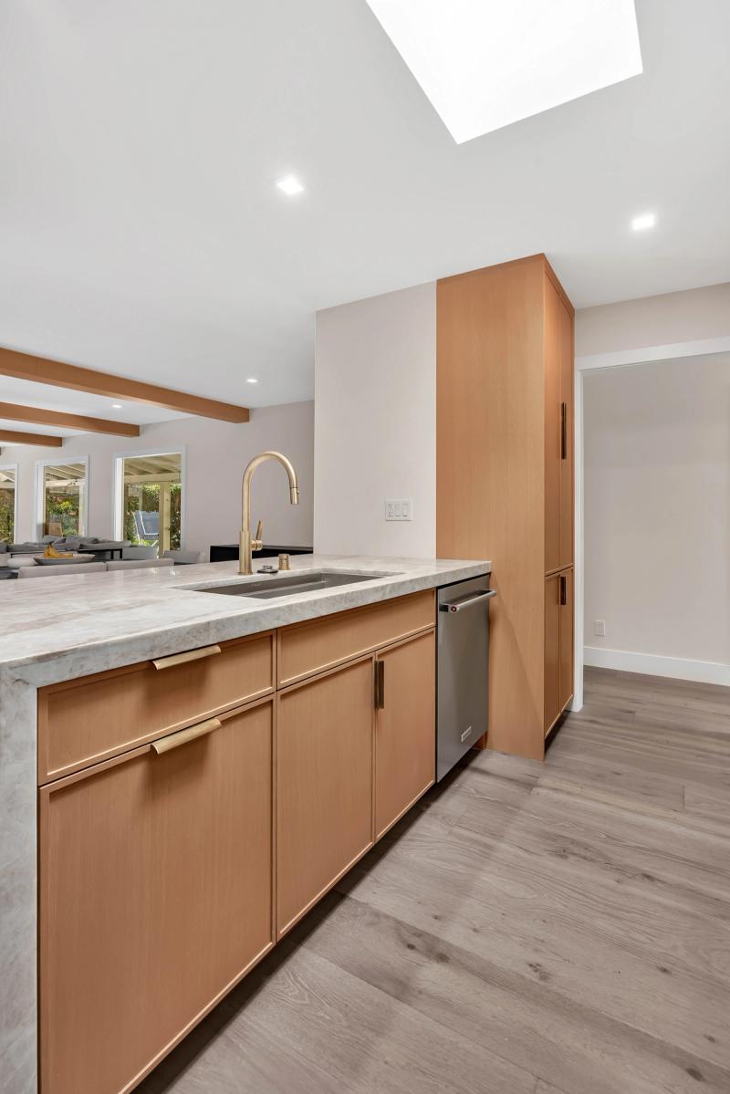 Living room, open concept view with sectional and kitchen beyond