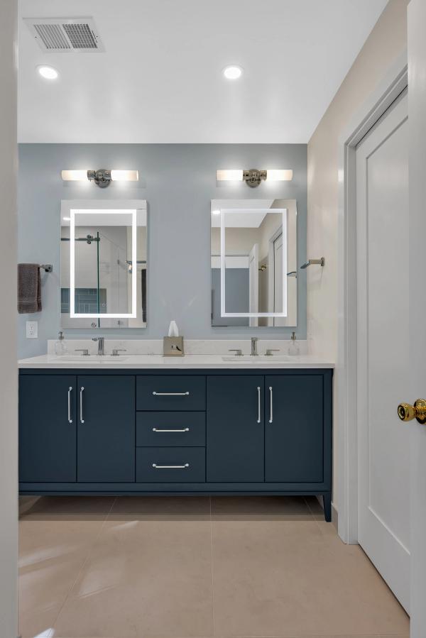 Master bath, navy double vanity closeup with quartz and LED mirrors