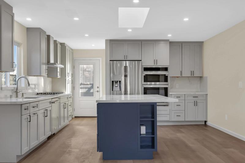 Kitchen, navy island with quartz top, Samsung fridge, and LG double wall oven