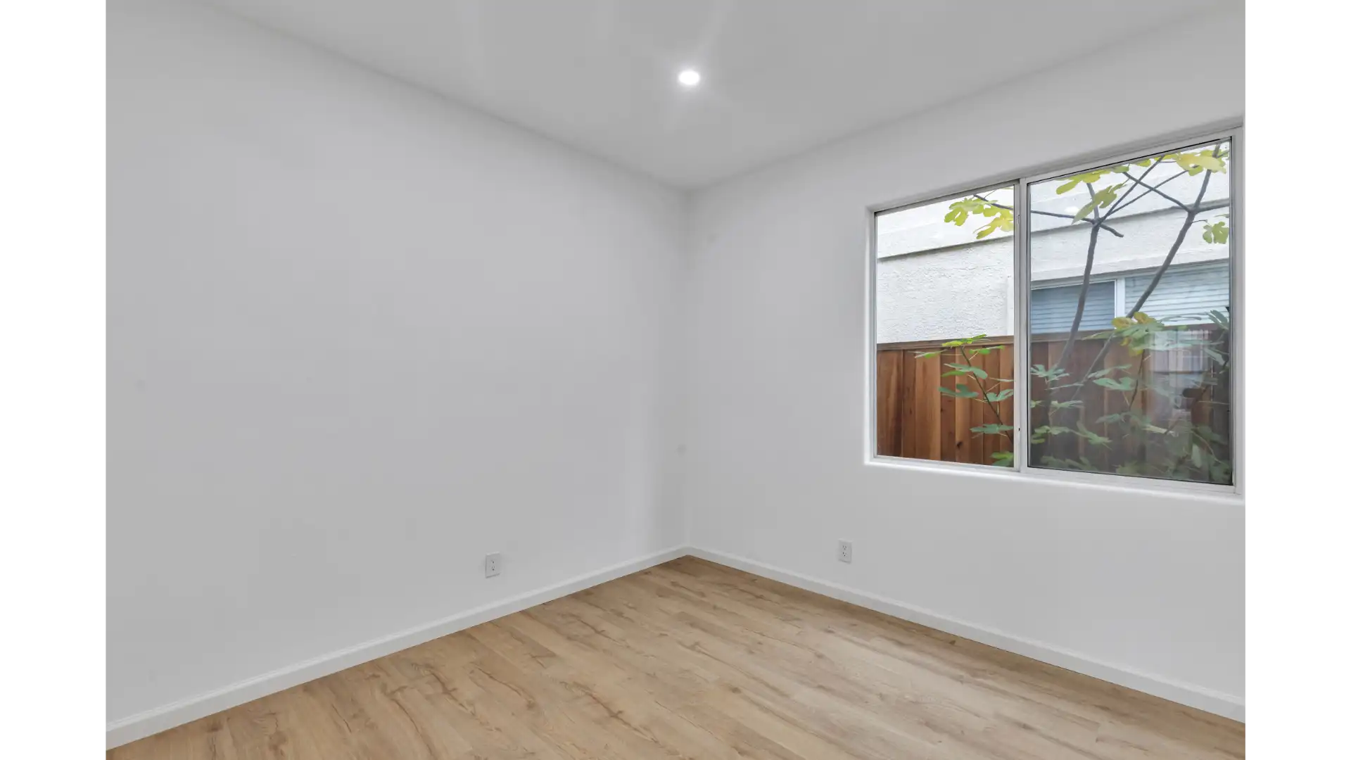 Interior sightlines — continuous flooring and vaulted ceiling through room addition