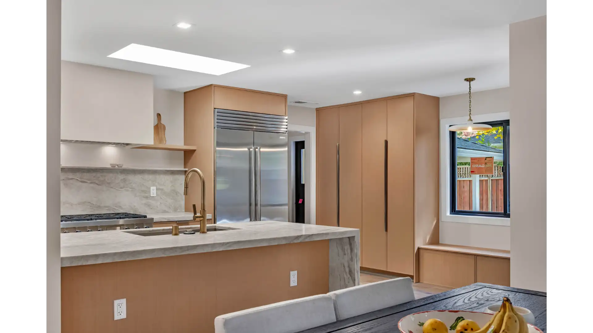 Kitchen showing natural stone countertops with cabinetry and fixtures