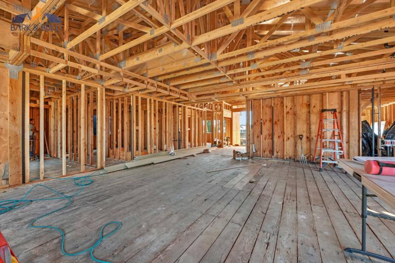 Vapor barrier installation — epoxy-sealed membrane over garage slab before subfloor