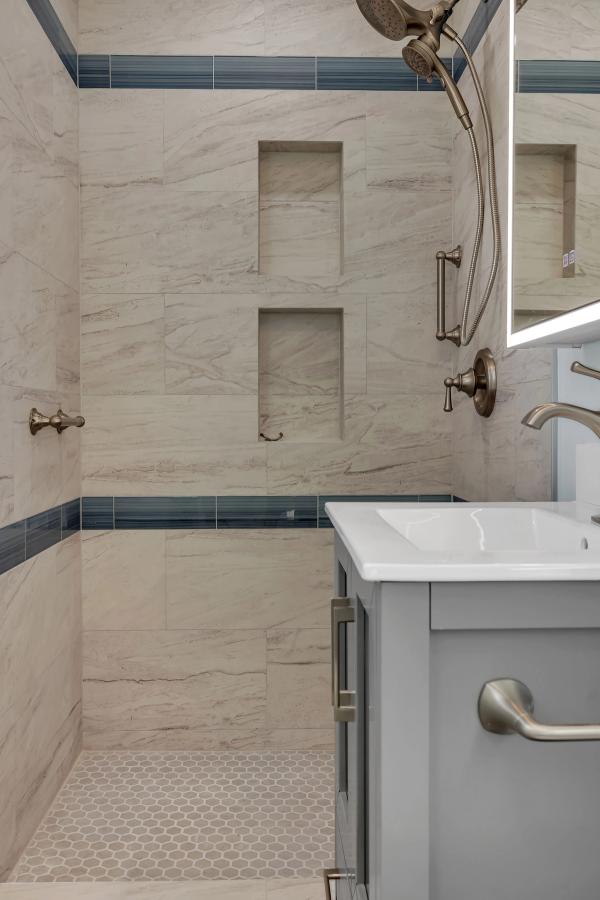 Bathroom, shower detail with dual recessed niches and hexagonal mosaic floor