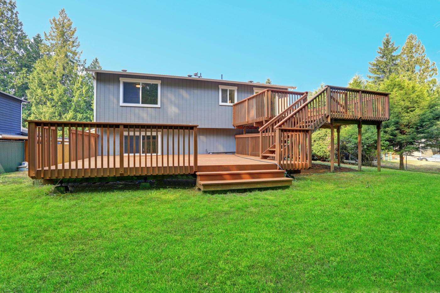 Two-level composite deck with elevated stair connection — Bark and Build Builders, Redwood City