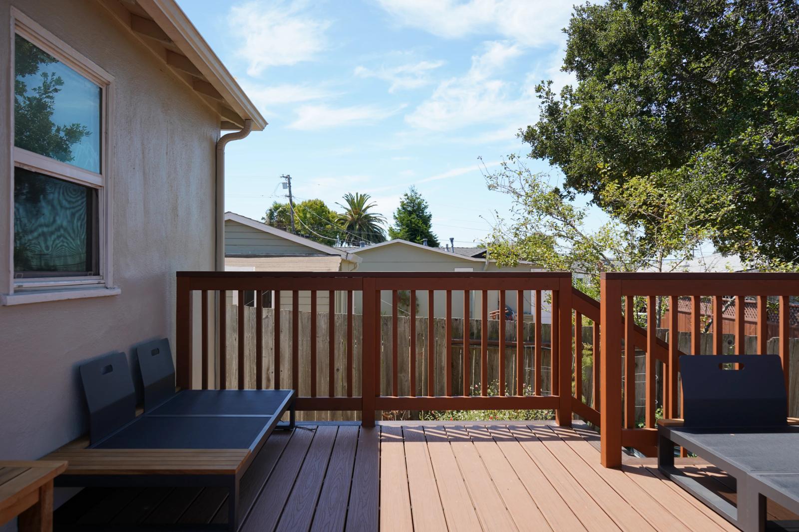 Completed Bark and Build composite deck with view toward the bay — Redwood City