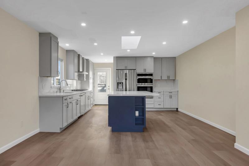 2065 Fiesta Ct kitchen, wide view with gray cabinetry, navy island, and stainless appliances