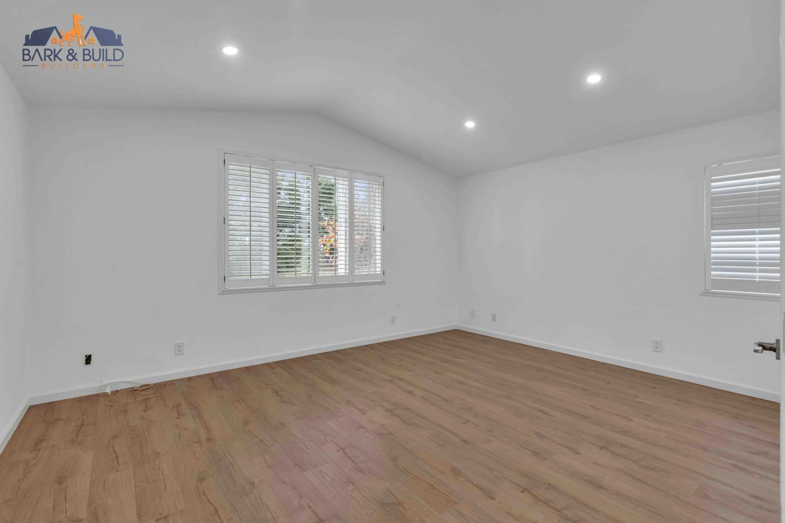 Completed outdoor living space — multi-level composite deck with outdoor kitchen and retaining walls