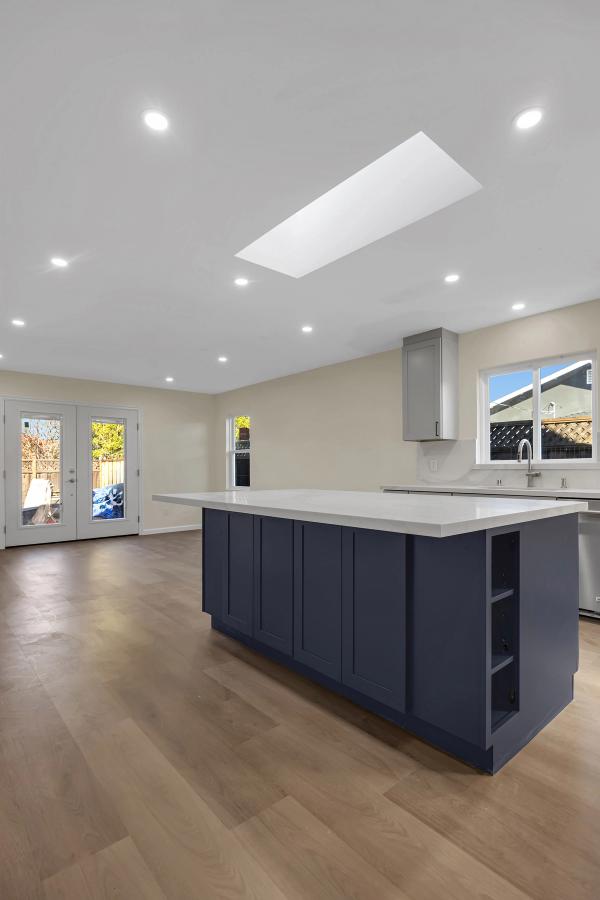 Kitchen, wide angle showing open-concept layout with skylight