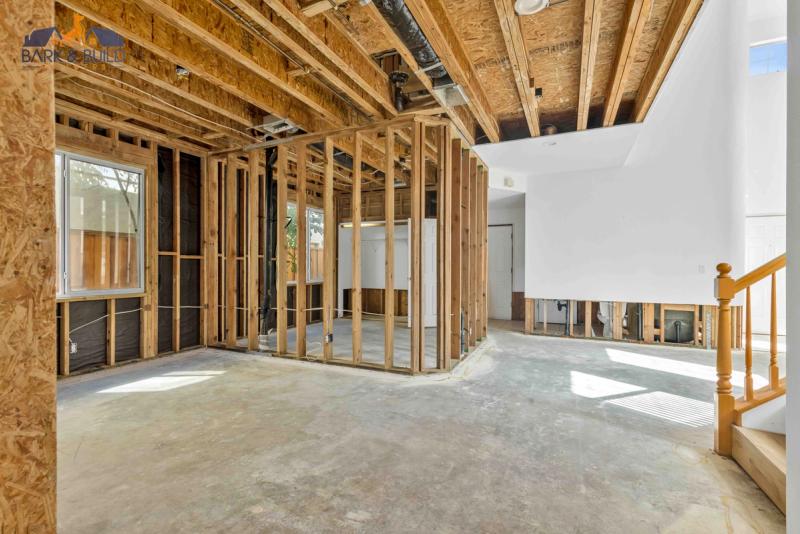 Outdoor living construction — custom deck framing and hardscaping