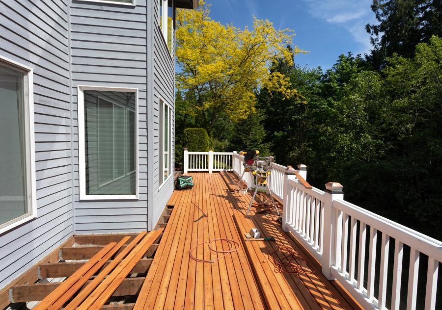 Deck mid-construction with miter saw and freshly laid composite boards — Redwood City build