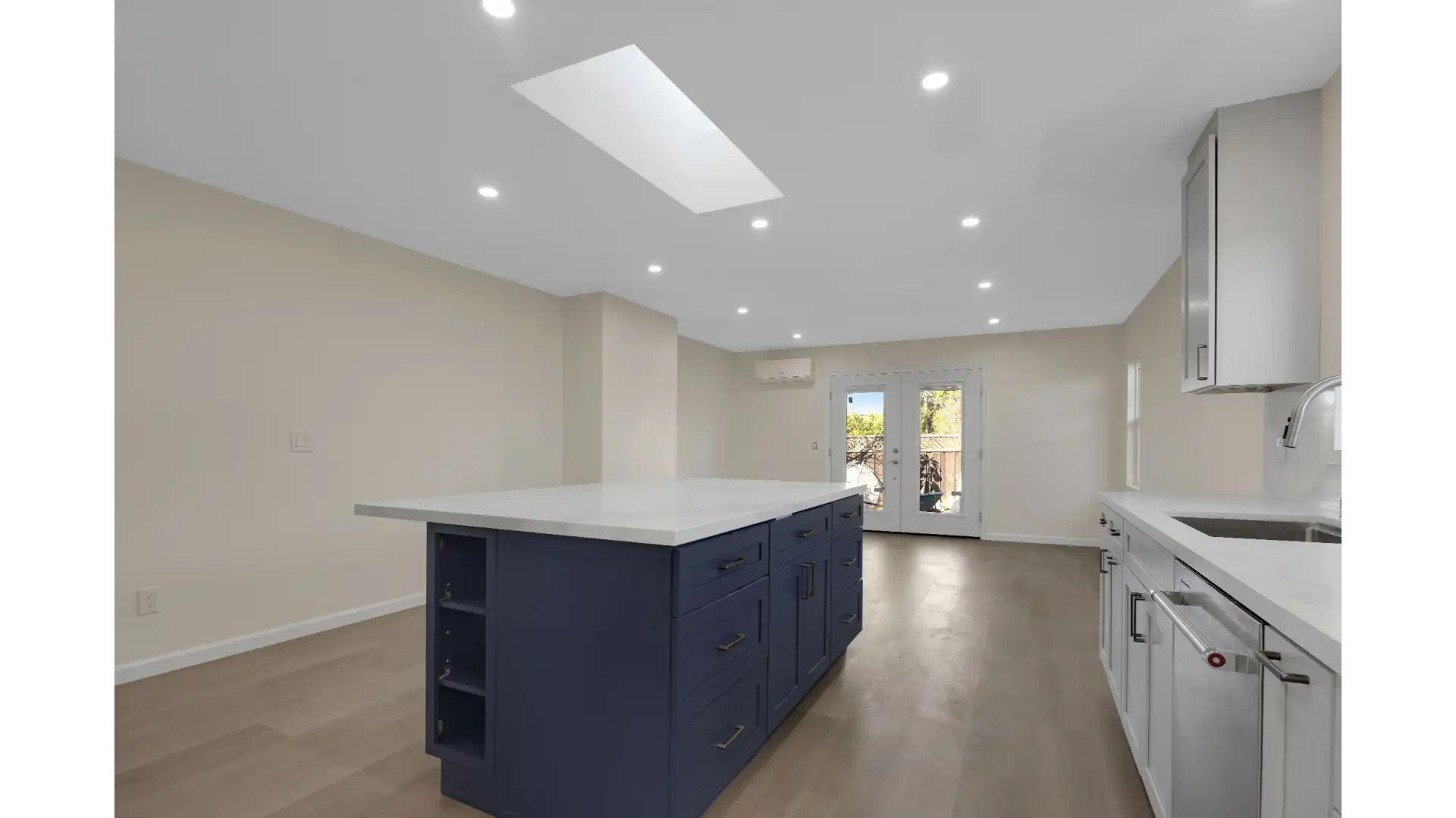 Kitchen after renovation — modern open concept with custom cabinetry and quartz countertops