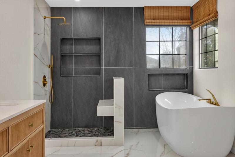 Buckingham Dr master bath, completed renovation with slate wall, tub, and gold fixtures