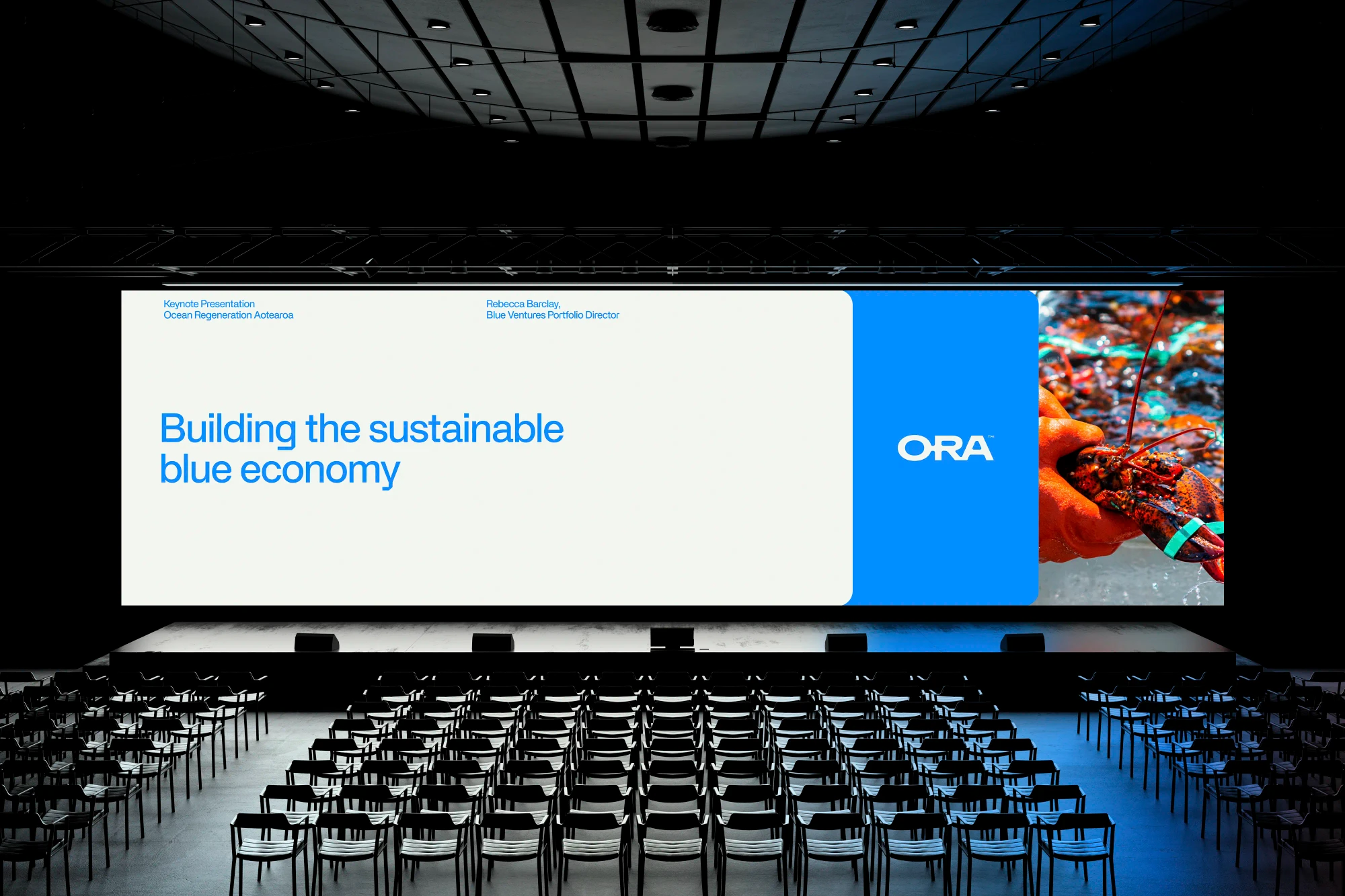 A conference screen displays layered ORA graphics.