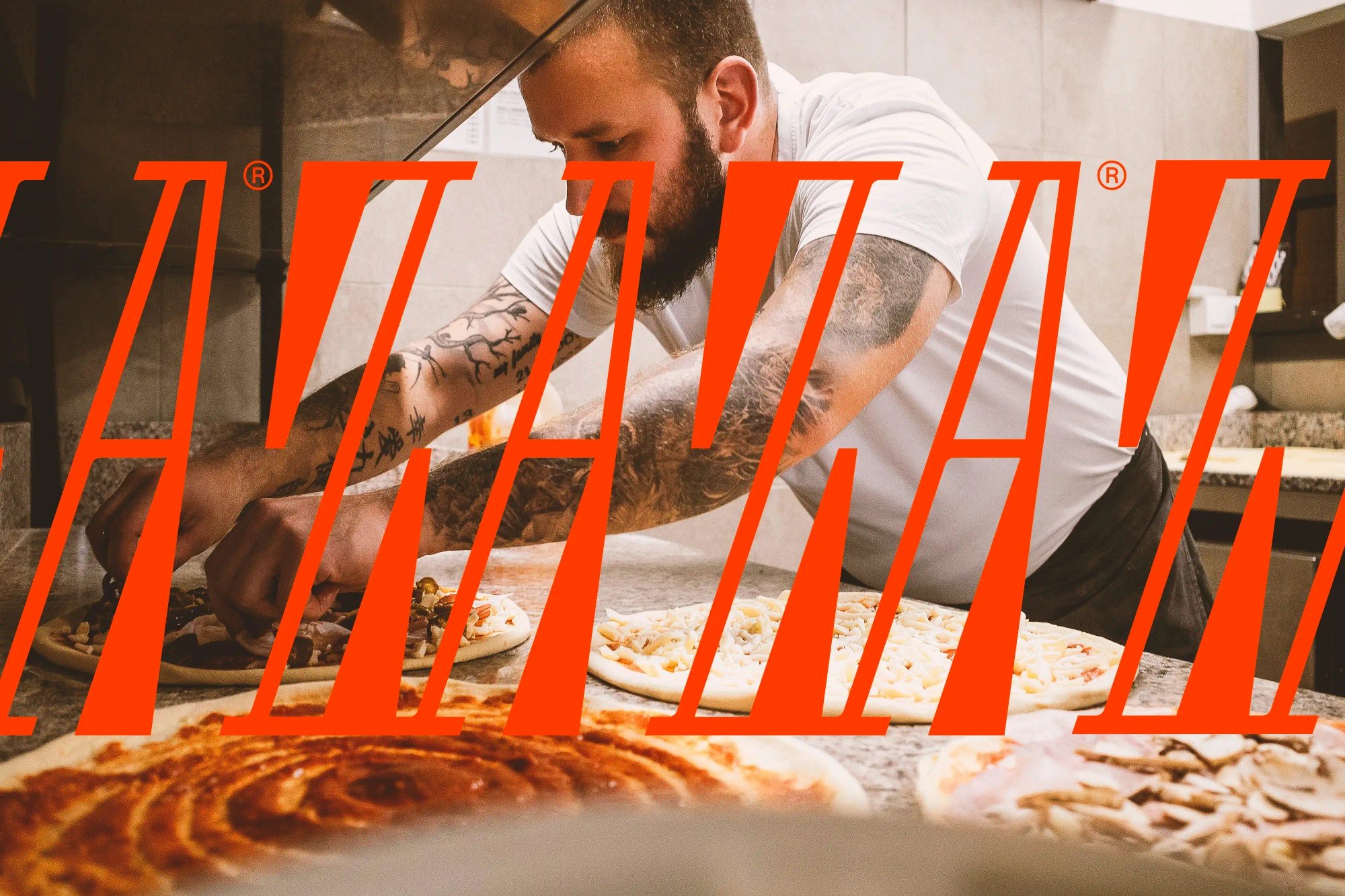A chef makes pizza in the restaurant kitchen.