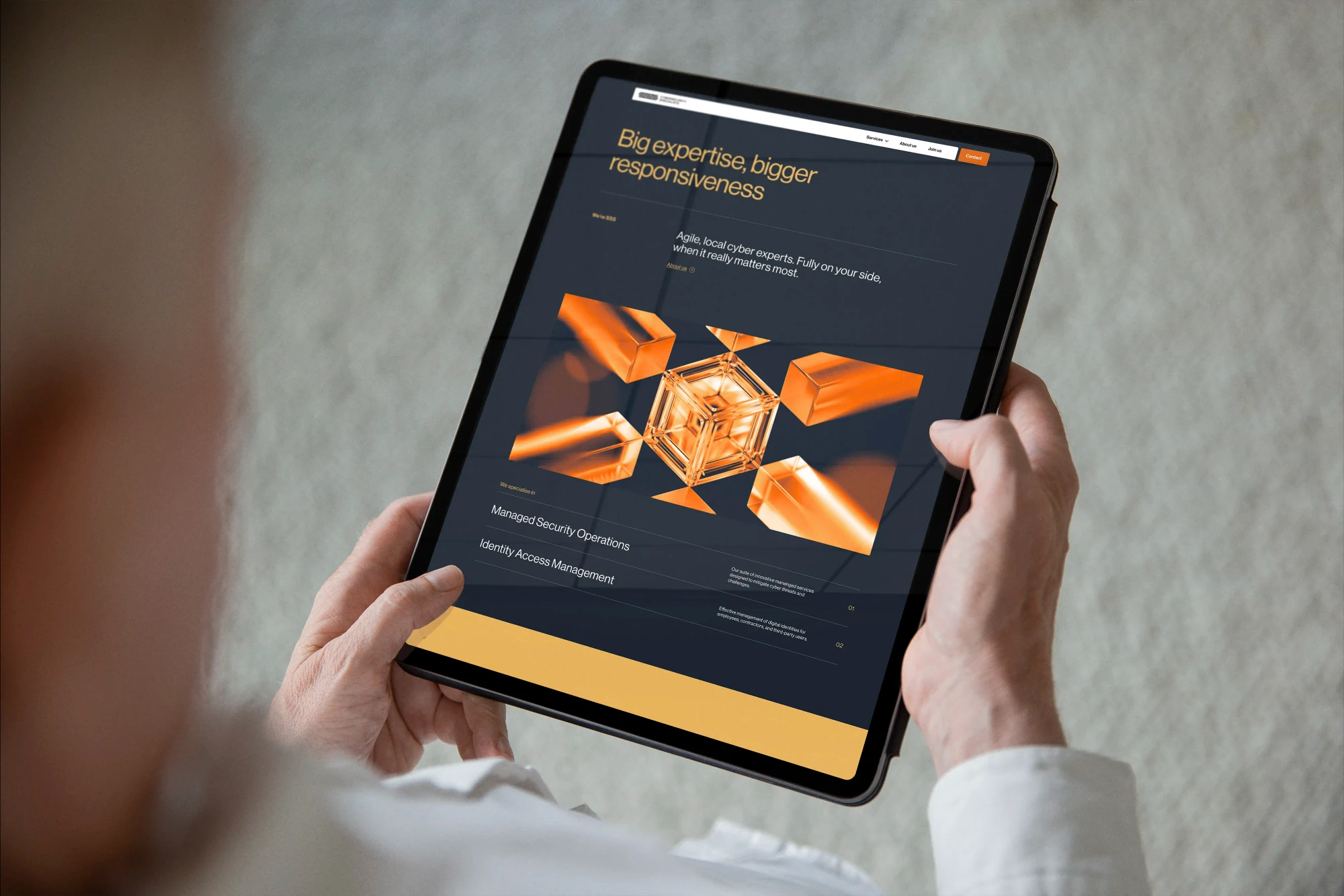 A business person holds an iPad featuring the triple-S website homepage