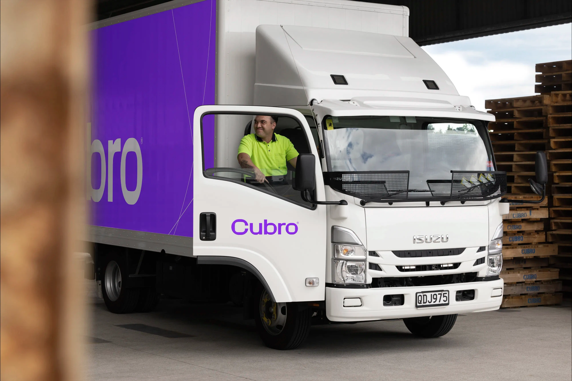 The Cubro logo sits large on the side of a purple and white commercial truck.