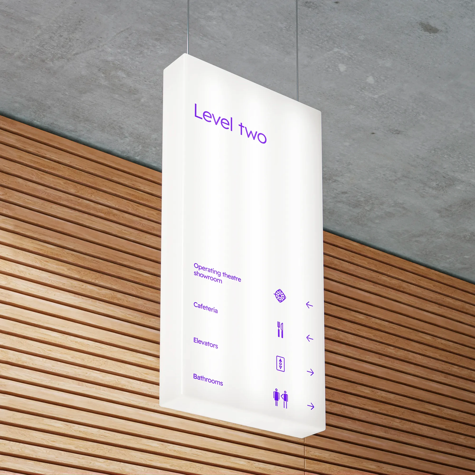 A hanging wayfinding sign features bespoke icons.